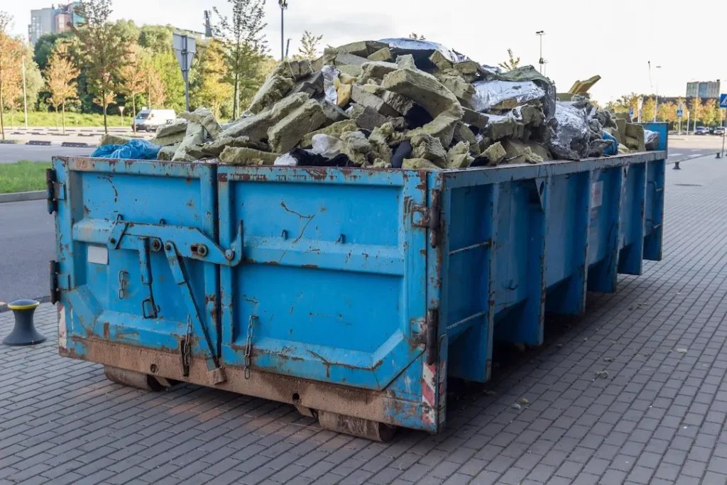 overflowing dumpster at business in louisiana with prohibited items