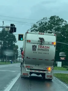 raccoon on garbage truck trash rangers