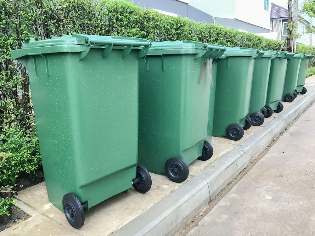 trash carts lined up along the curb on pickup day