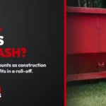 Debris or trash? The side of a red Trash Rangers roll-off dumpster on a grass lot.