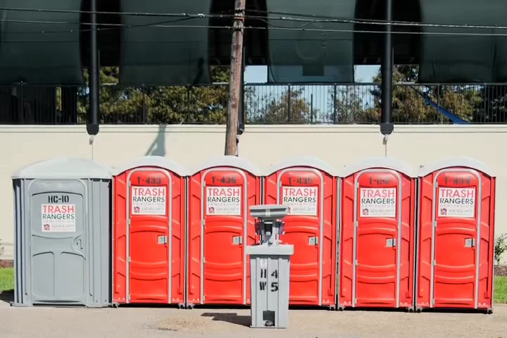 Trash Rangers portable toilets in a row with a hand wash station in front at Jambalaya Park in Gonzales